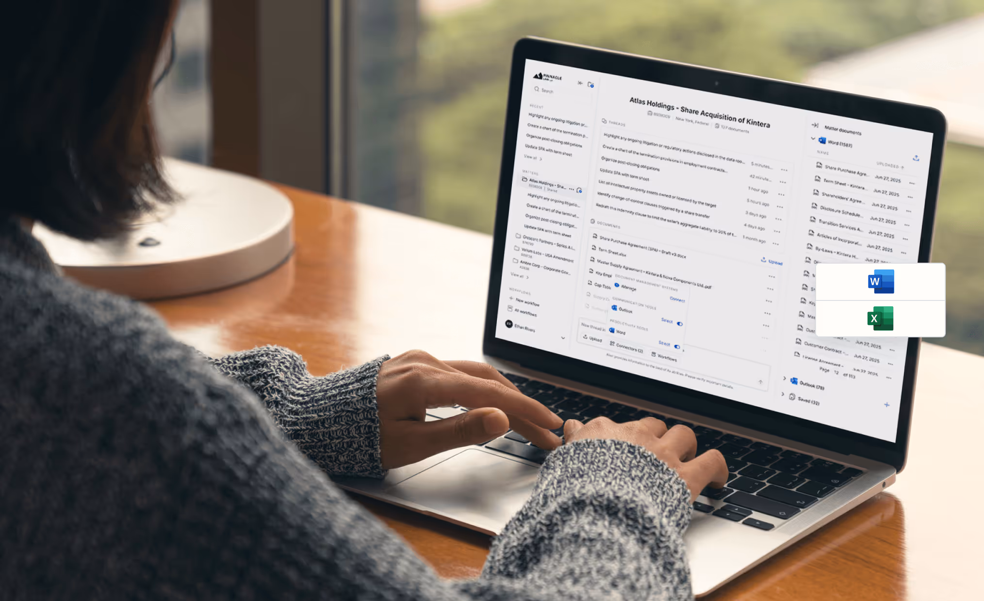 Person typing on a laptop displaying a document management interface titled Atlas Holdings - Share Acquisition of Kintera.