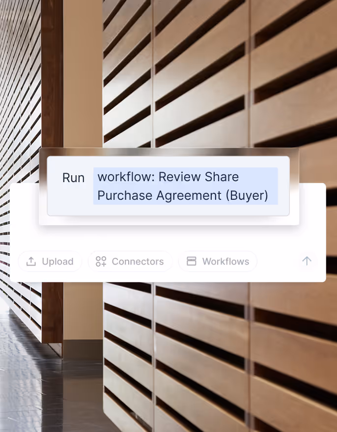 Close-up of a software interface with a highlighted command to run the workflow 'Review Share Purchase Agreement (Buyer)' on a background of modern wooden wall panels and tiled floor.