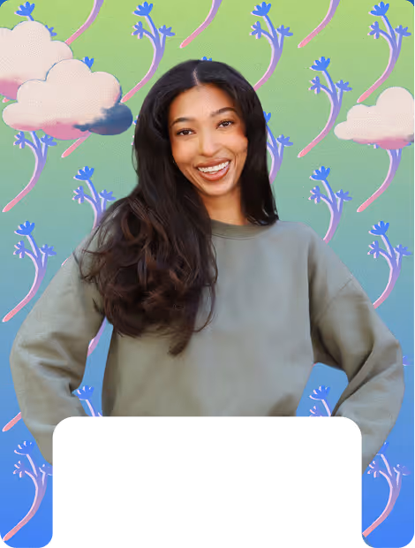 Smiling woman with long dark hair wearing a gray sweatshirt standing against a colorful background with abstract floral and cloud designs.