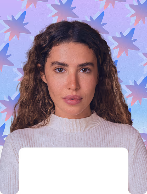 Woman with long curly hair wearing a white sweater, standing against a colorful star-patterned background.