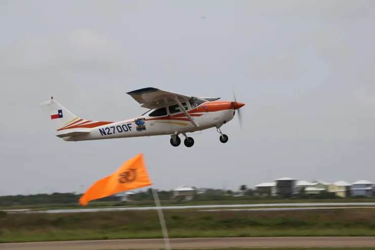 Skydive South Texas Cessna jump plane with windsock at the Port Aransas dropzone