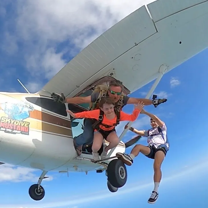Two skydivers exiting the jump plane over Port Aransas, Texas