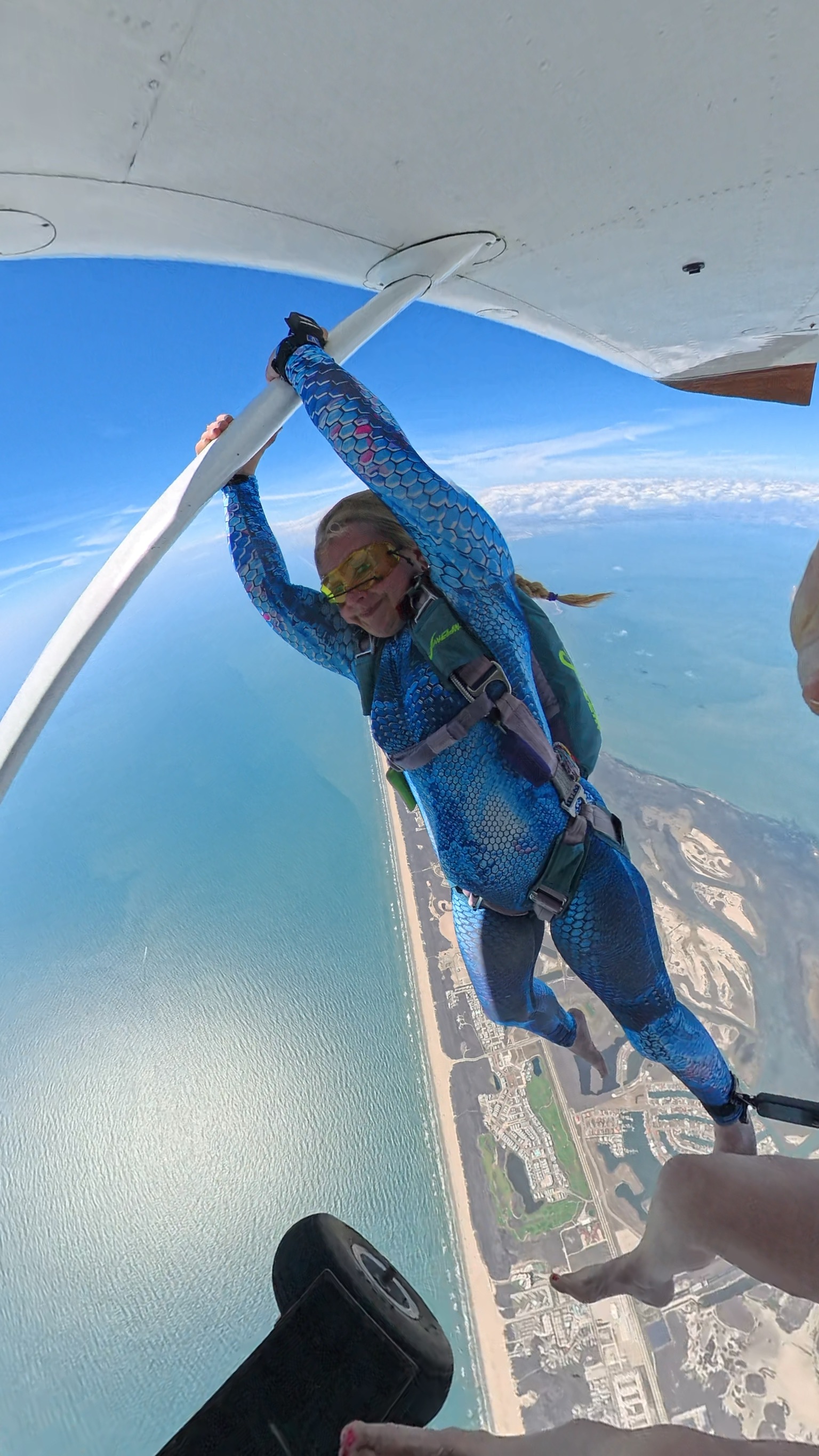Tandem skydiving exit hanging from the aircraft over Mustang Island
