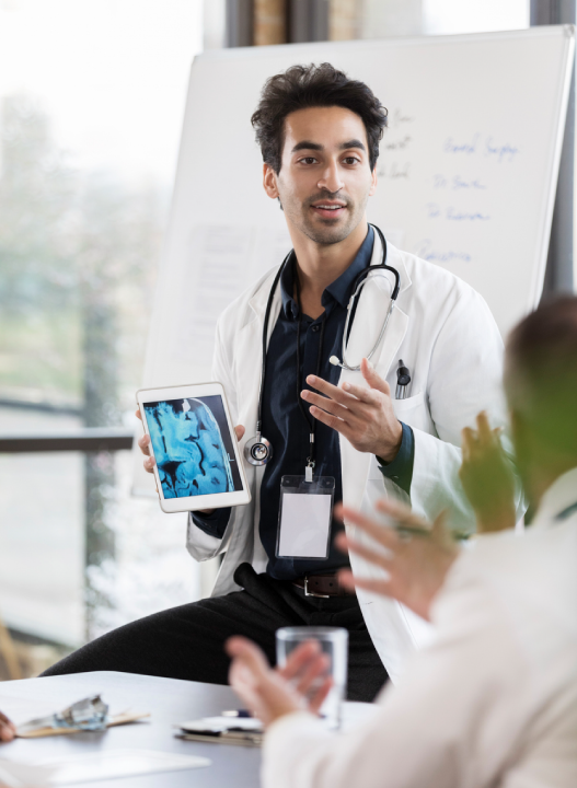 Doctor presenting a tablet during a meeting.