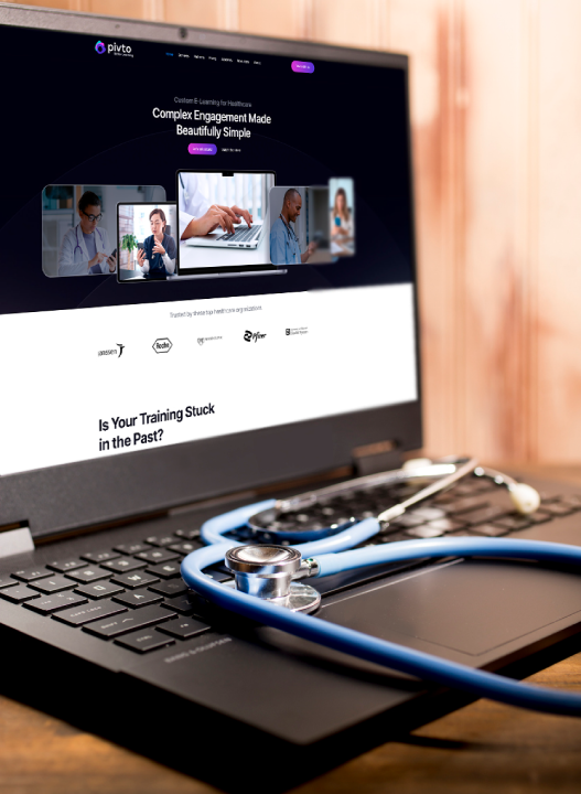 Laptop with a website open and a clipboard on the desk.