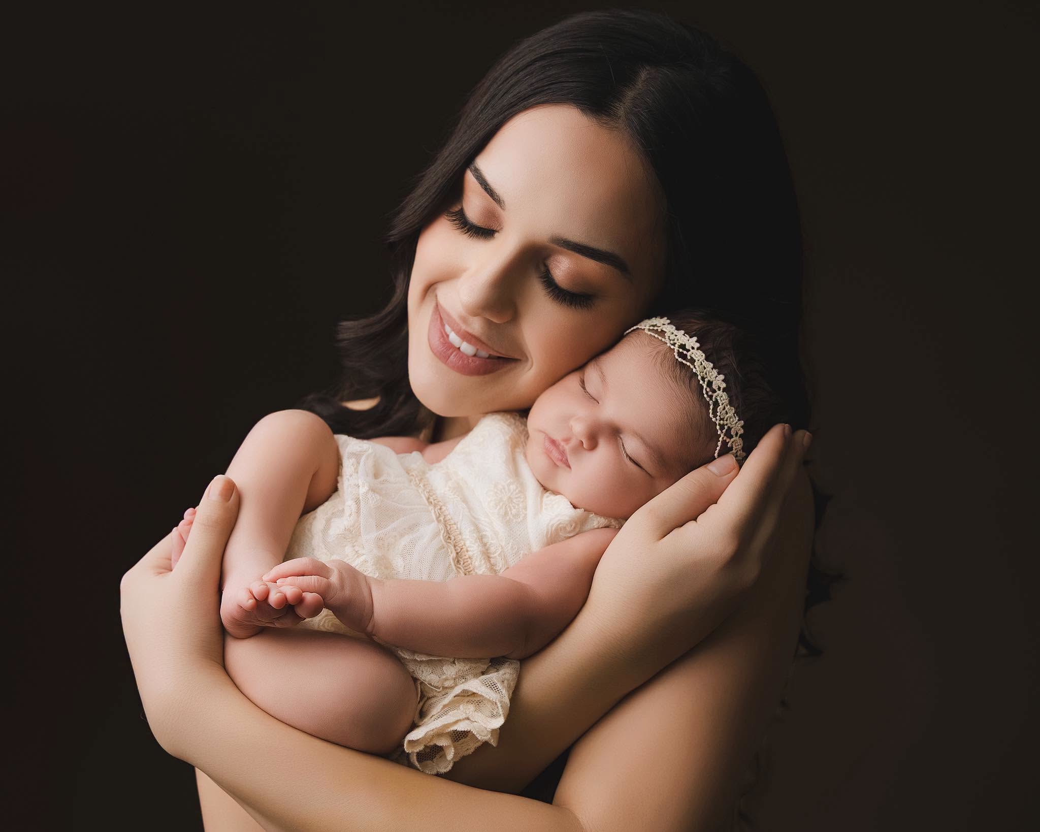 Christy cradling her sleeping baby
