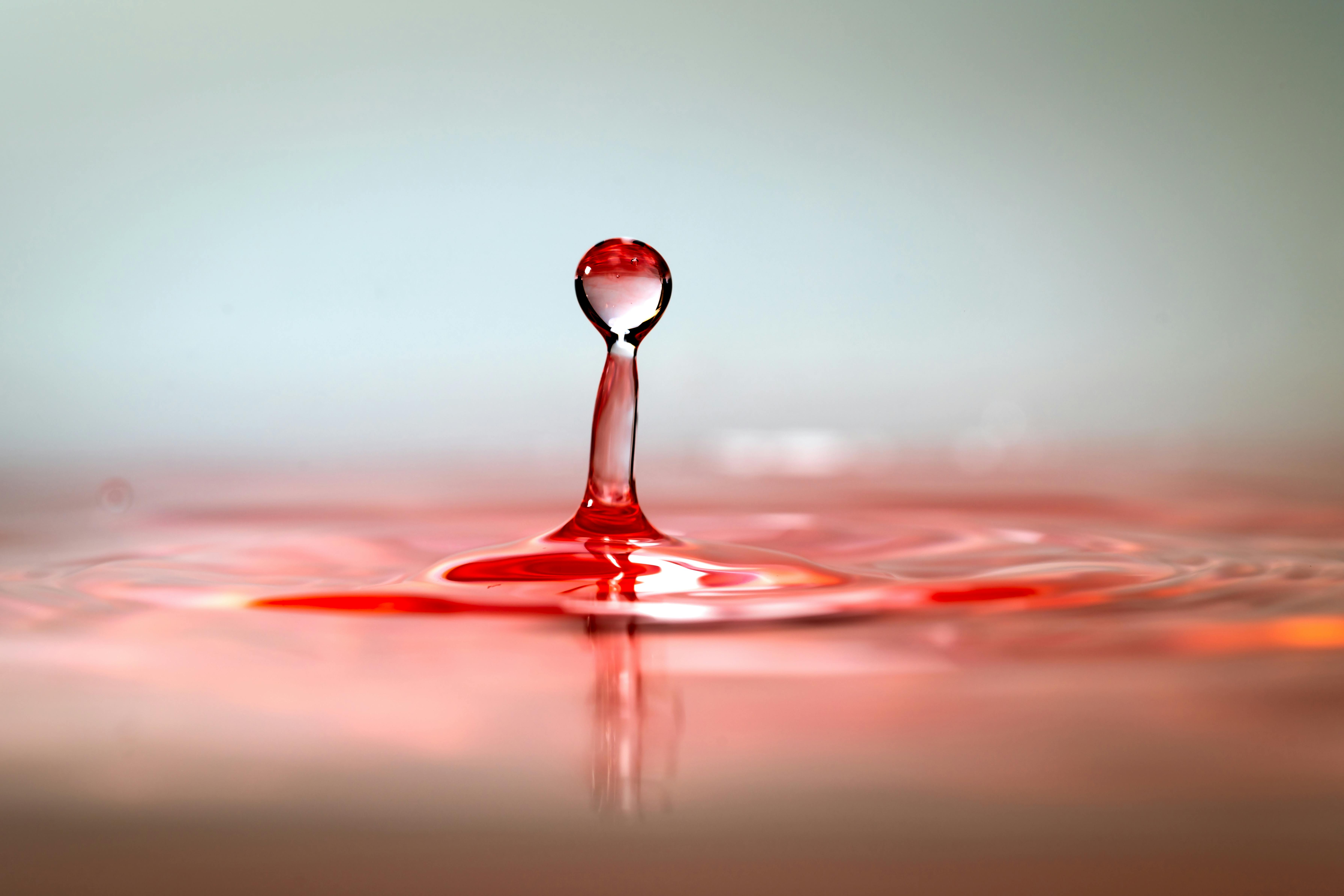 A splash of wine coming up from the surface of red wine