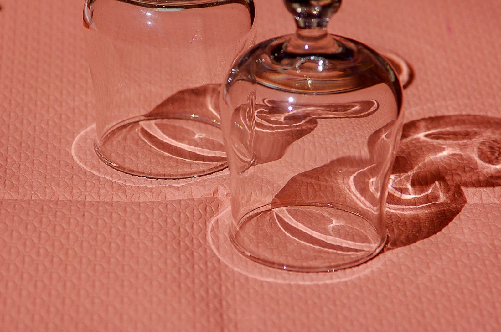two wine glasses inverted on a pink tissue paper