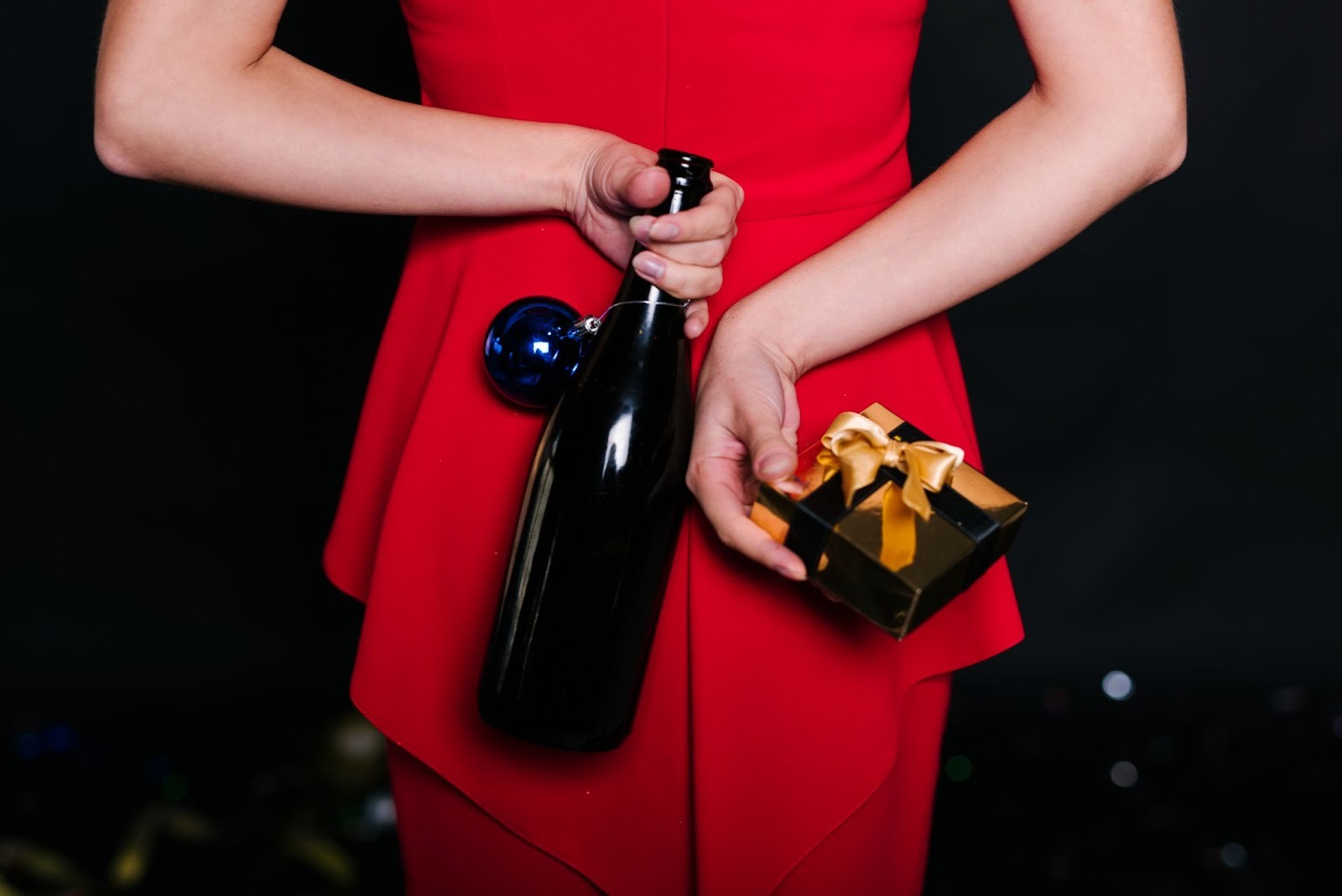 woman-holding-bottle-with-gift-box