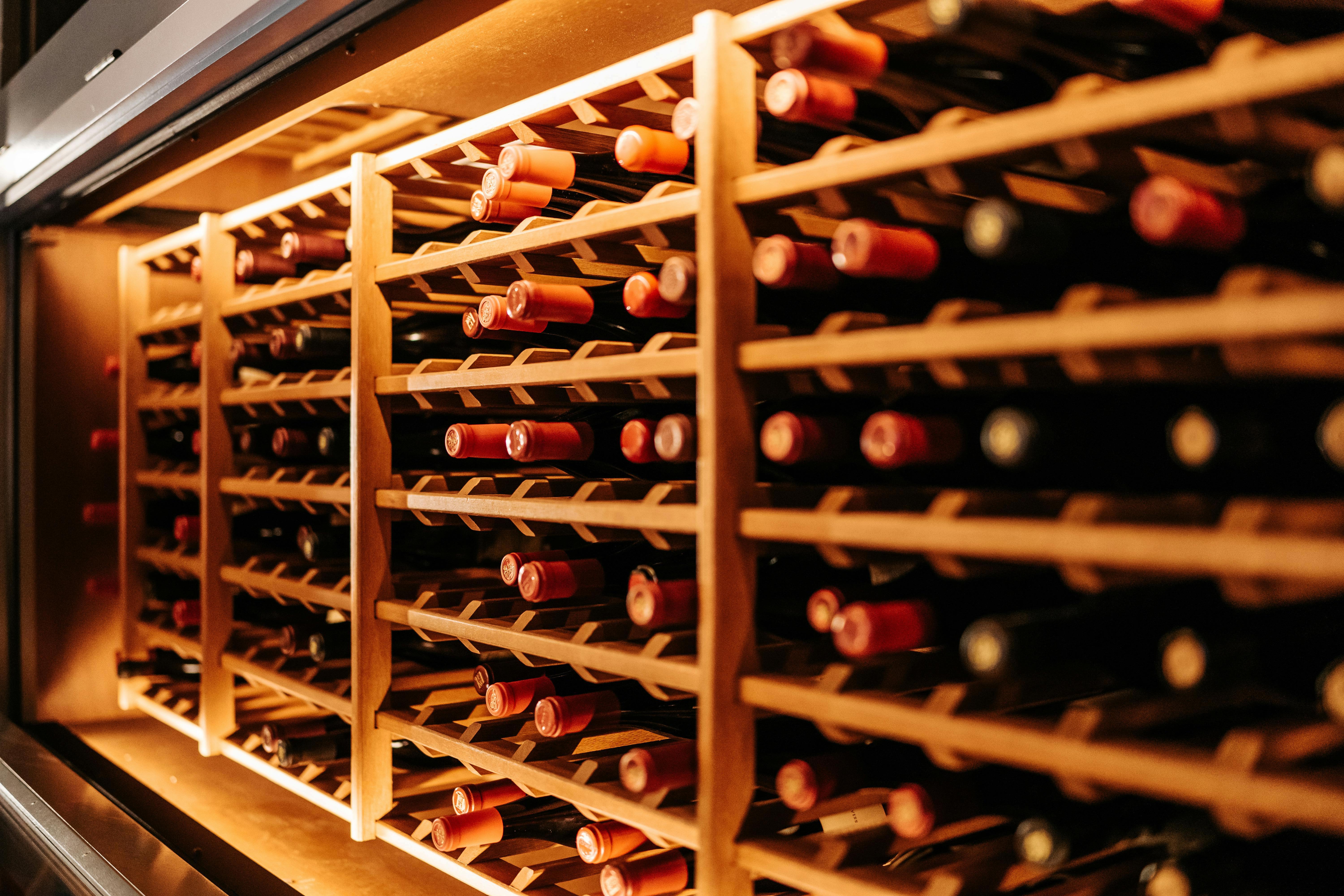 Wine bottles stacked in cold storage in home wine cellar
