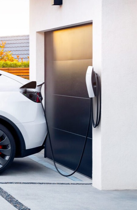 Photo d'une borne de recharge Tesla installé par Khematec. Celle-ci est branchée sur une voiture.