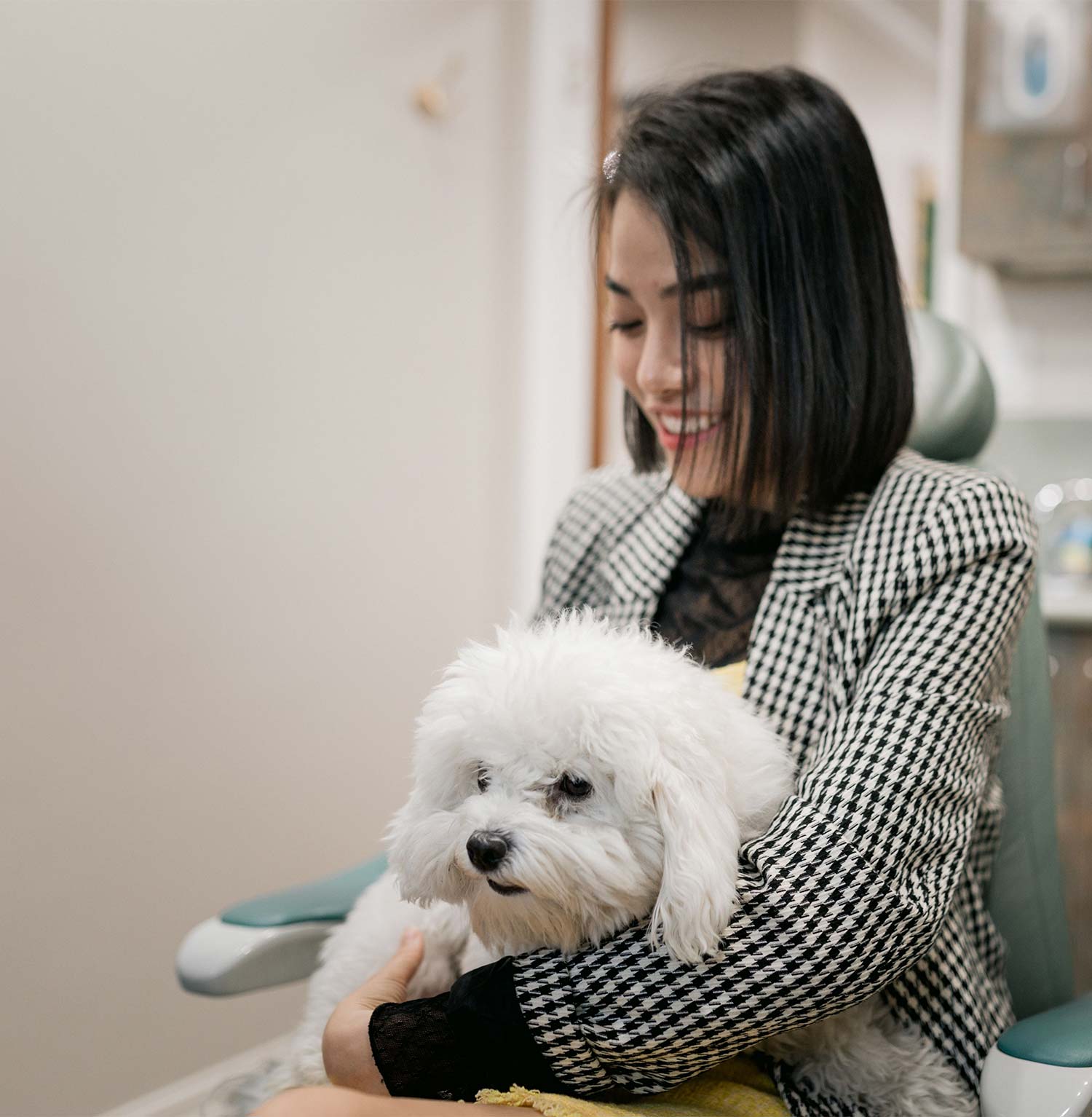 A patient holds Coconut, our emotional support dog