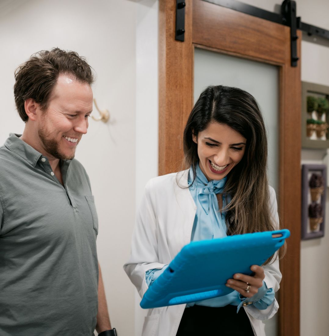 Dr. Kazemi laughing with a male patient