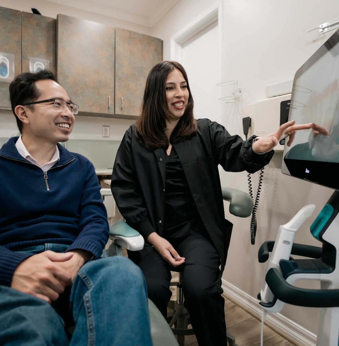 Hygienist looking at a male's patient xrays