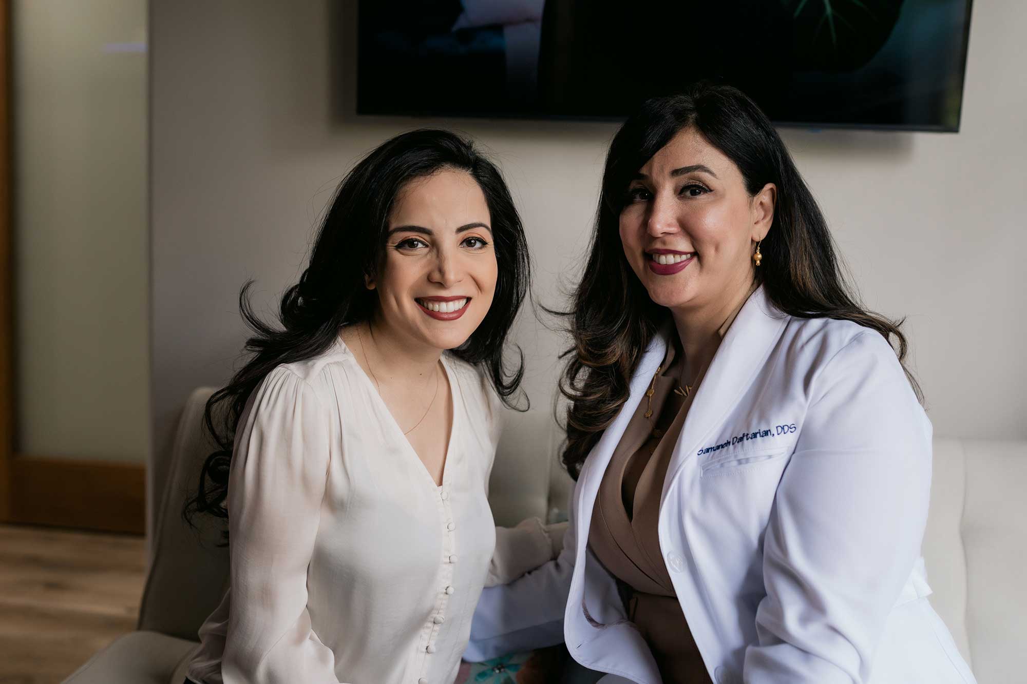 A dentist and patient smiling