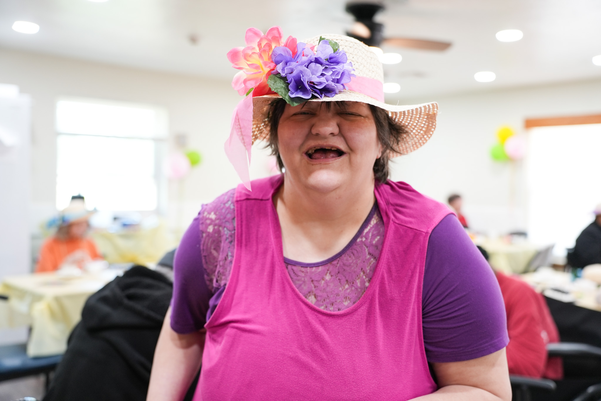 Elderly woman holding a turtle smiling