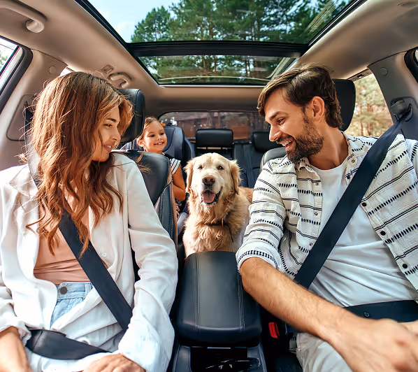 Family with dog in car.