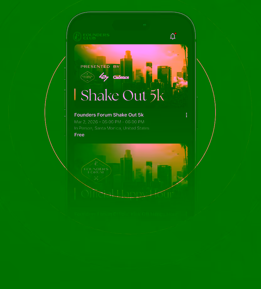 Two people working on laptops at a table, one wearing headphones and glasses, with a potted plant nearby.