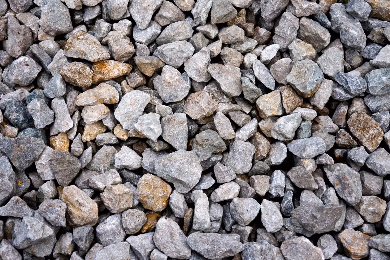 Close-up of a pile of irregular gray and brown gravel stones.