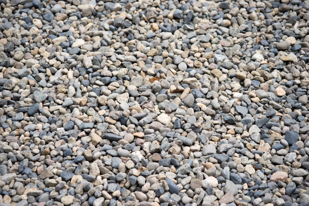 Close-up view of a large collection of small, smooth, multicolored pebbles.