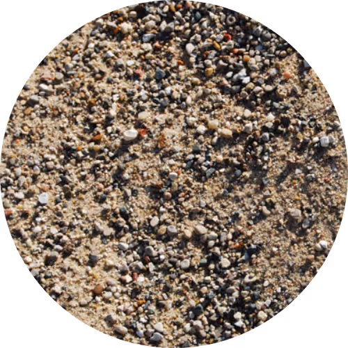 Close-up view of coarse sand with mixed small pebbles and grains.