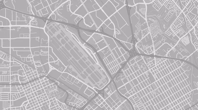 Grayscale map showing an urban area with a large airport runway complex in the center surrounded by streets.