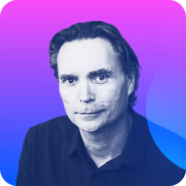 Portrait of a man with dark hair wearing a black shirt against a purple and blue gradient background.