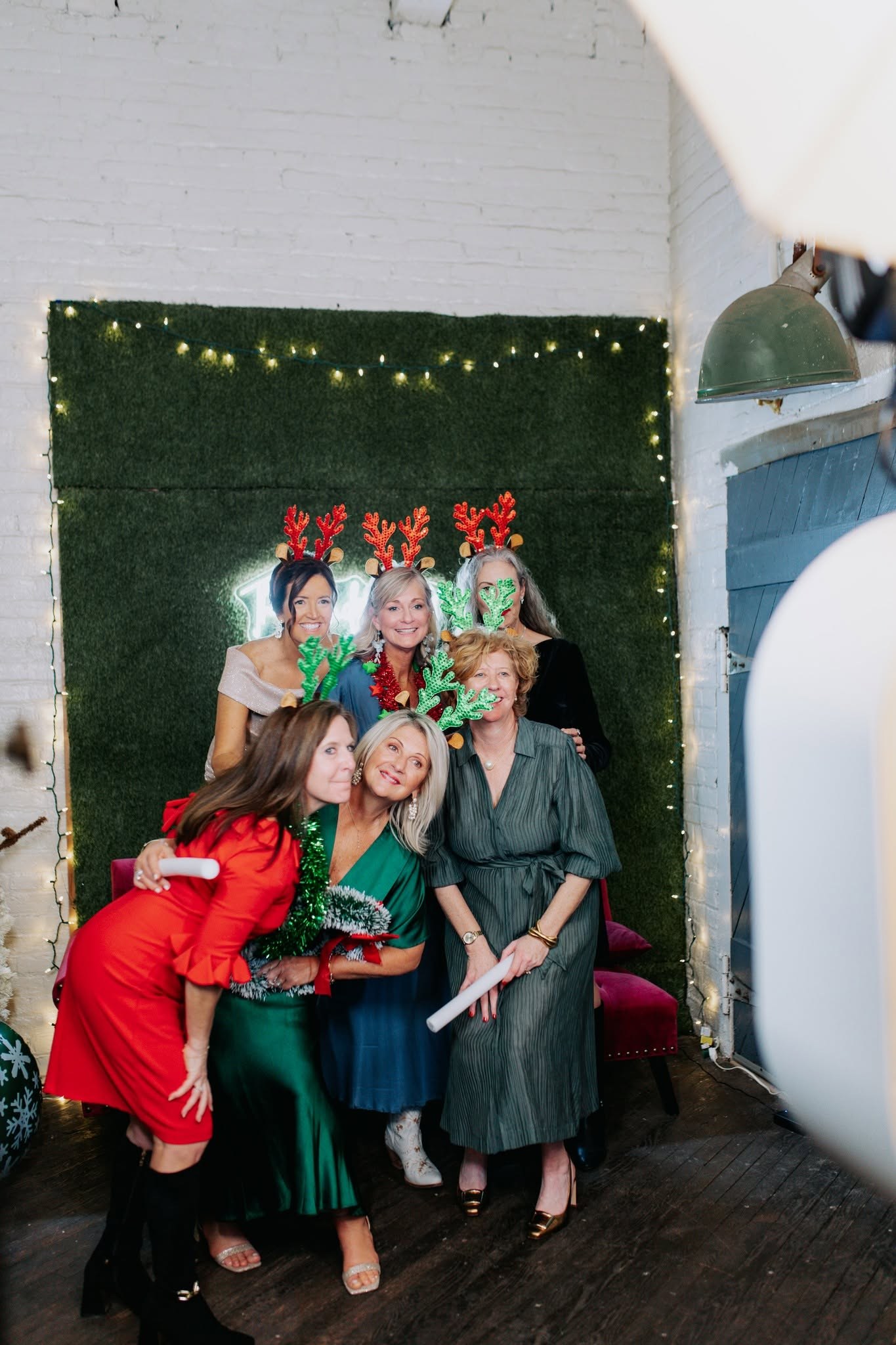 Guests in reindeer antlers at a holiday party at The Venue at 939