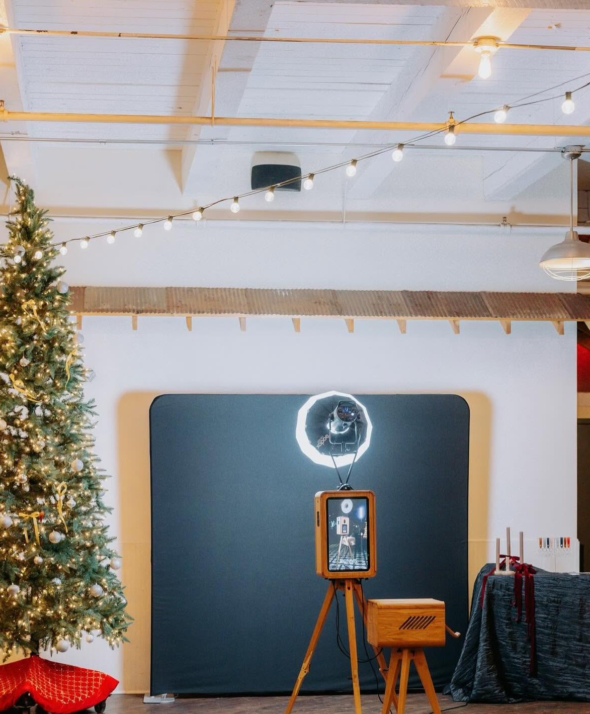 Holiday photo booth and Christmas tree set up inside The Venue at 939