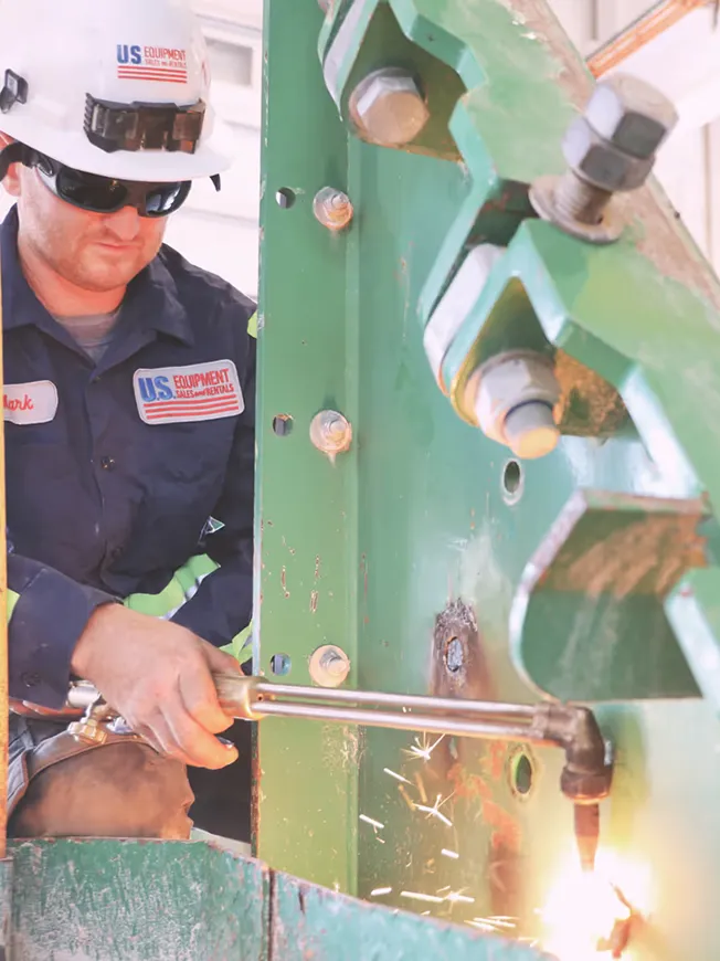 A man in a hard hat working on a machine.