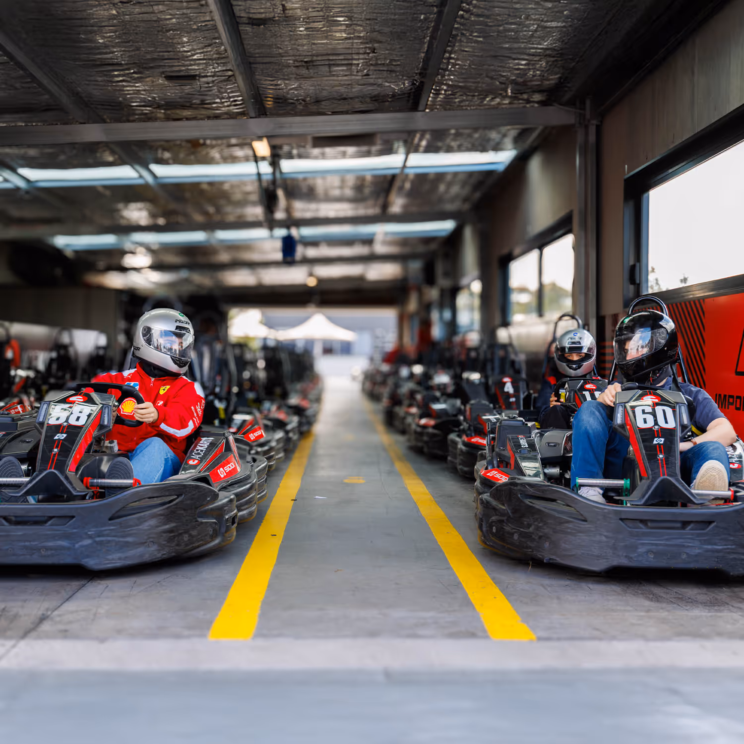 Christmas party group at Ace Karts with the pit building in the background.