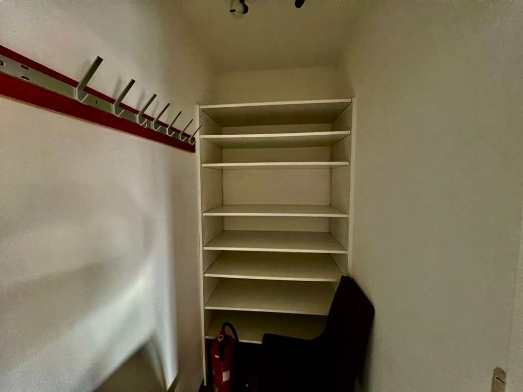 Kleiner Abstellraum mit Regalböden und Feuerlöscher
