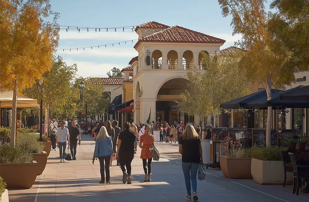 People walking and gathering in an outdoor plaza with Mediterranean-Fullerton