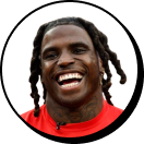 A close up of a person with dreadlocks.