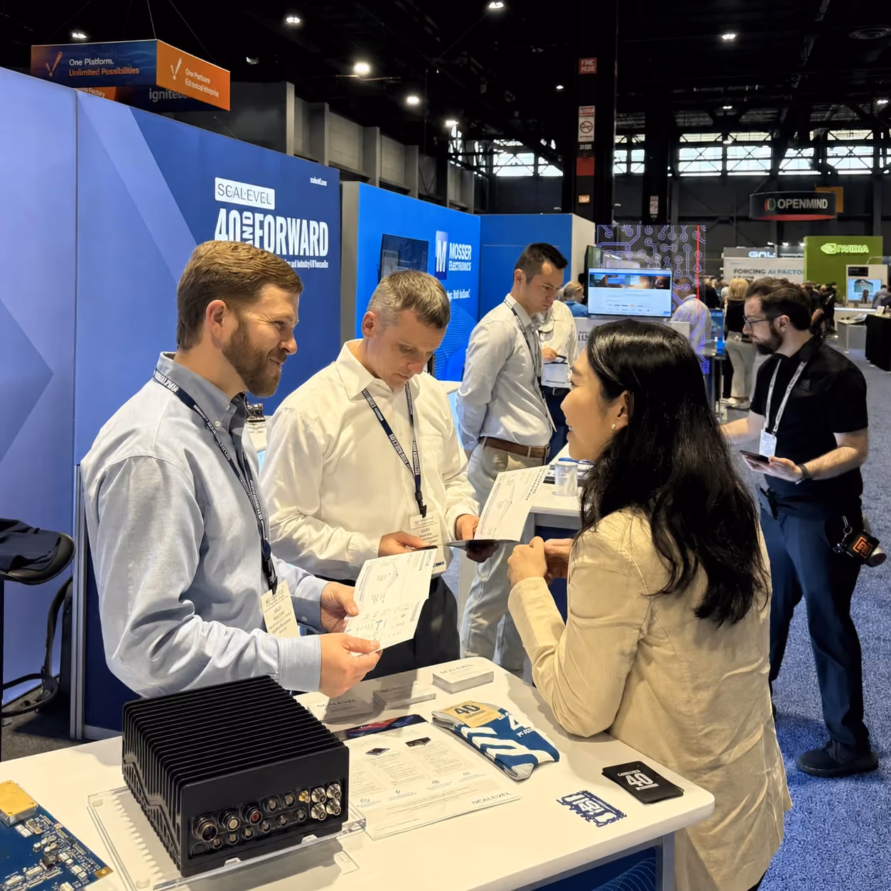 Business conversation at a technology trade show booth