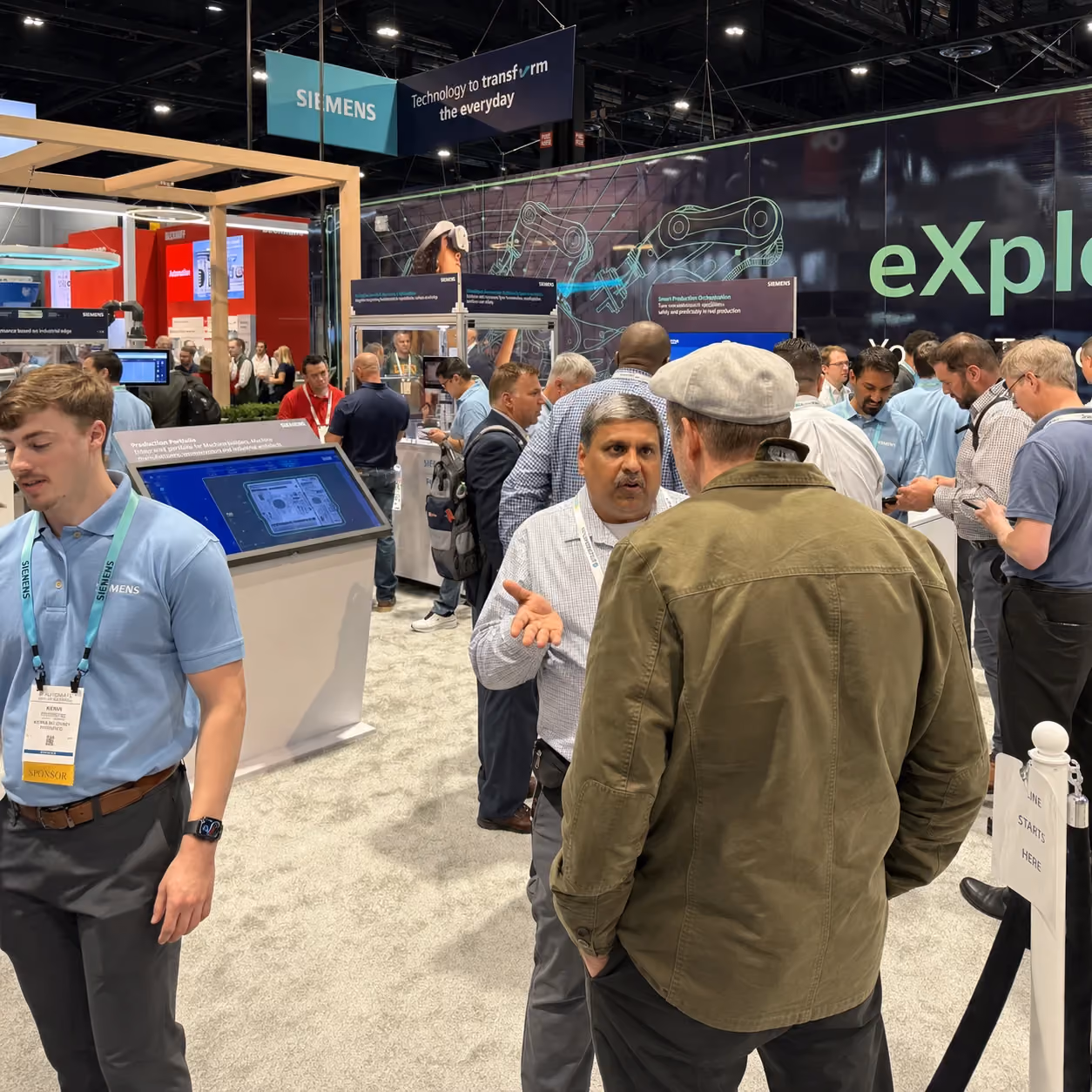 Crowded Siemens booth on the trade show floor