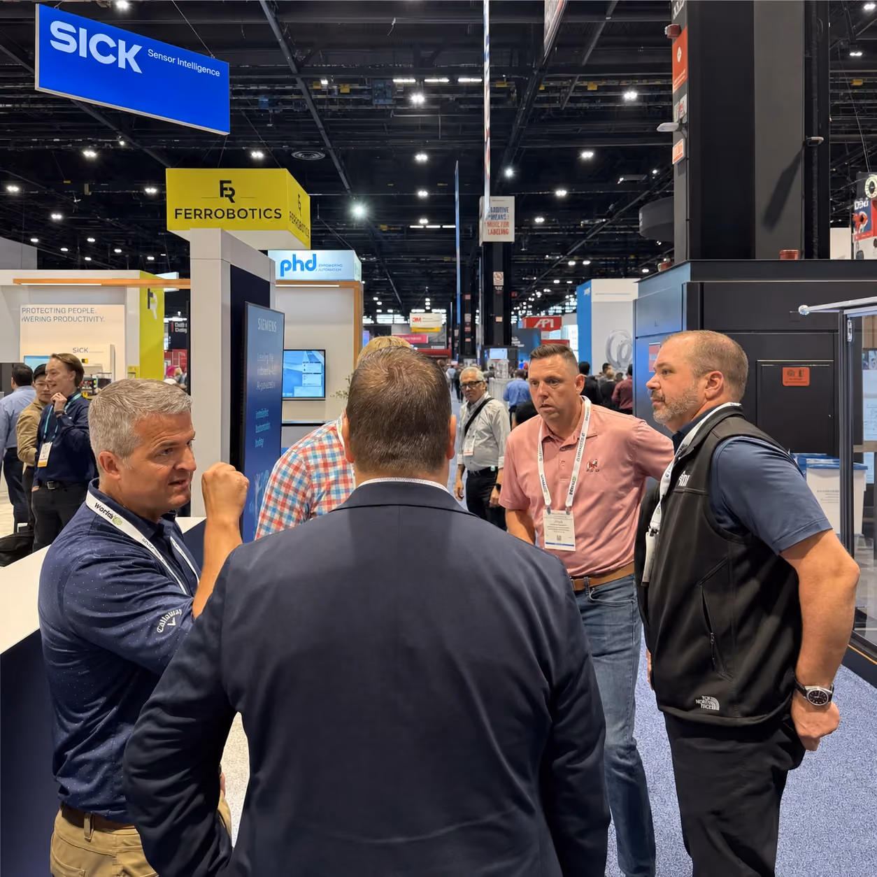B2B attendees in a focused show-floor conversation