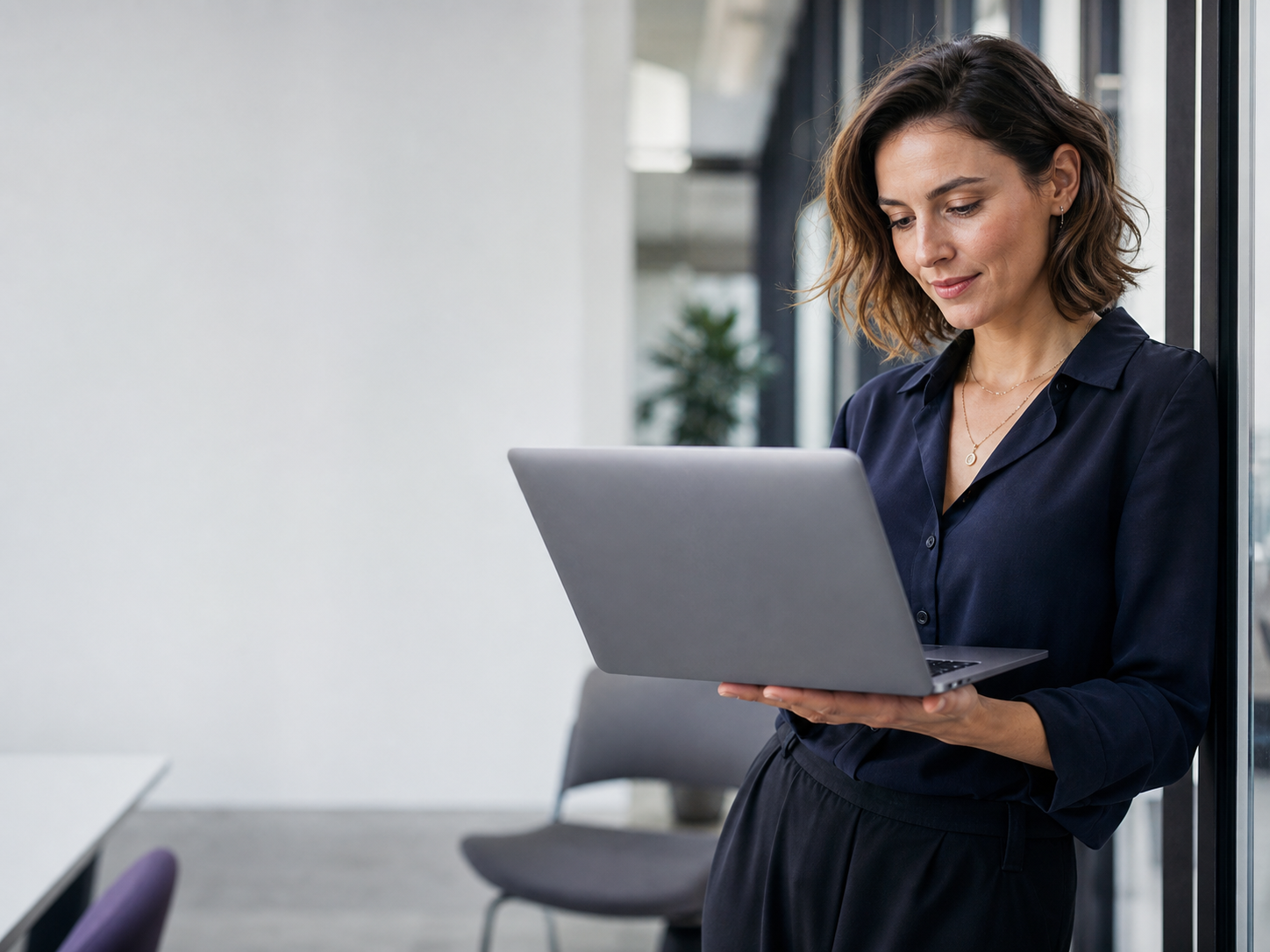 B2B growth manager reviewing event intelligence data on a laptop in a modern office