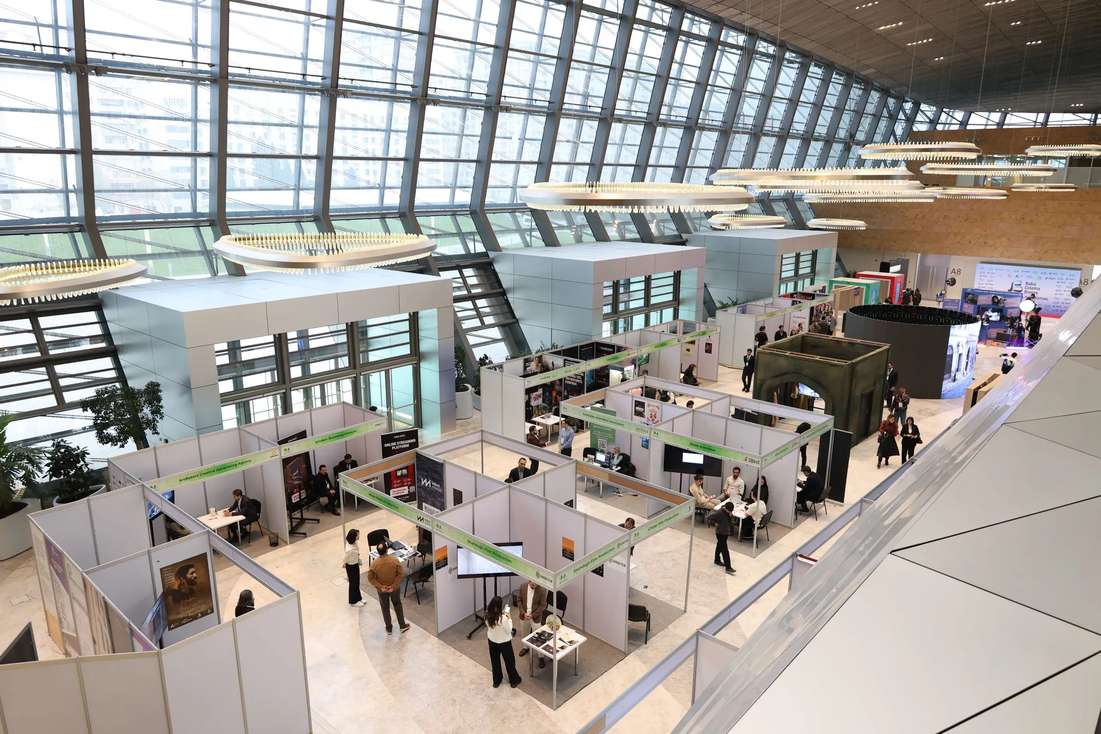 A real exhibition hall with visitors moving between business booths