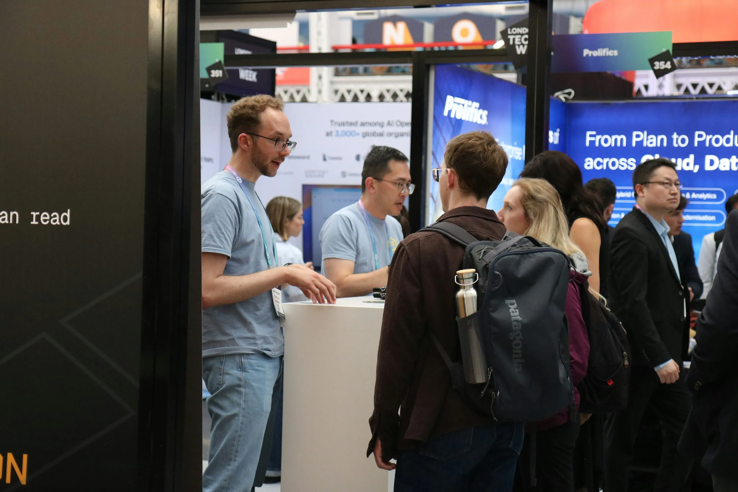 Exhibitors talking with visitors at a technology trade show