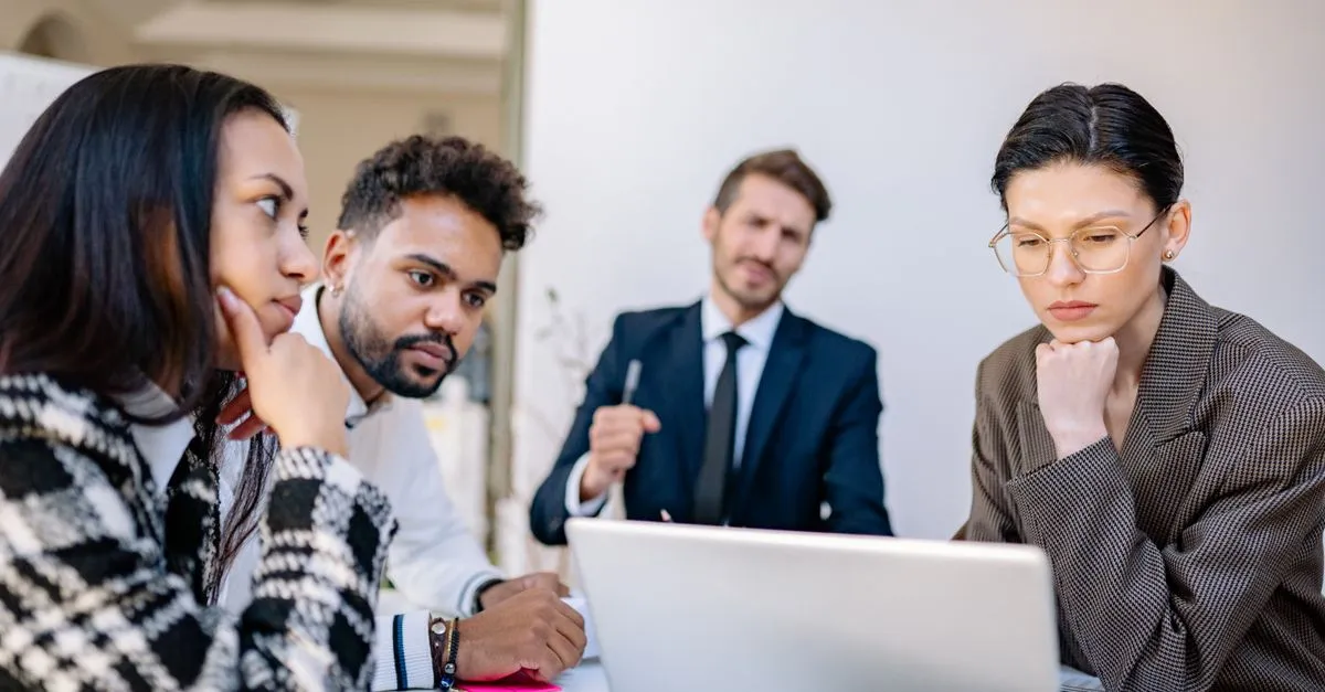 A team evaluating company research together on a laptop