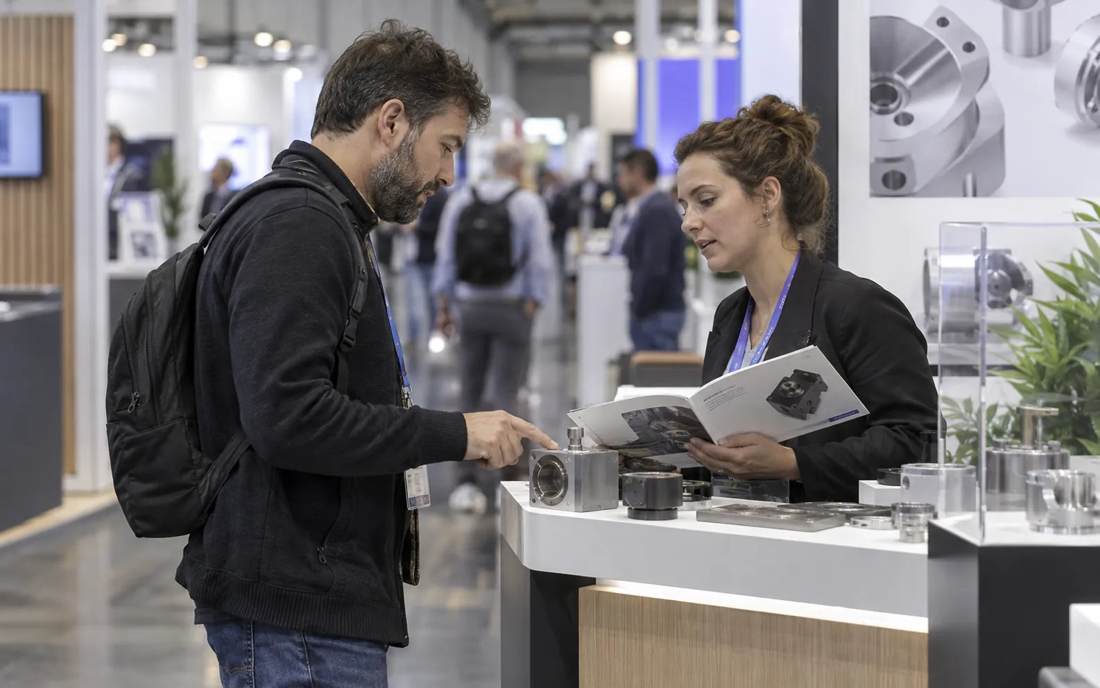 Generated scenario: a visitor and exhibitor discussing a product sample with relevant company context