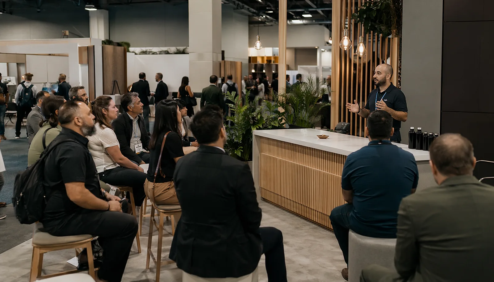 Content-led trade show booth workshop with attendees listening to a live session