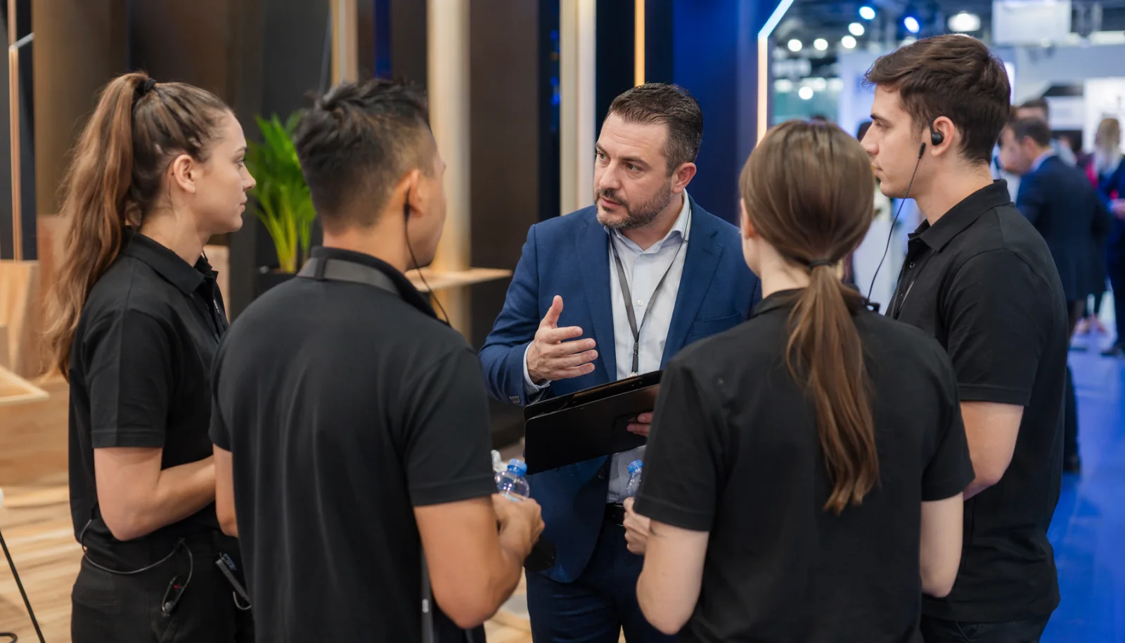 Event staffing coordinator briefing brand ambassadors before a trade show opens