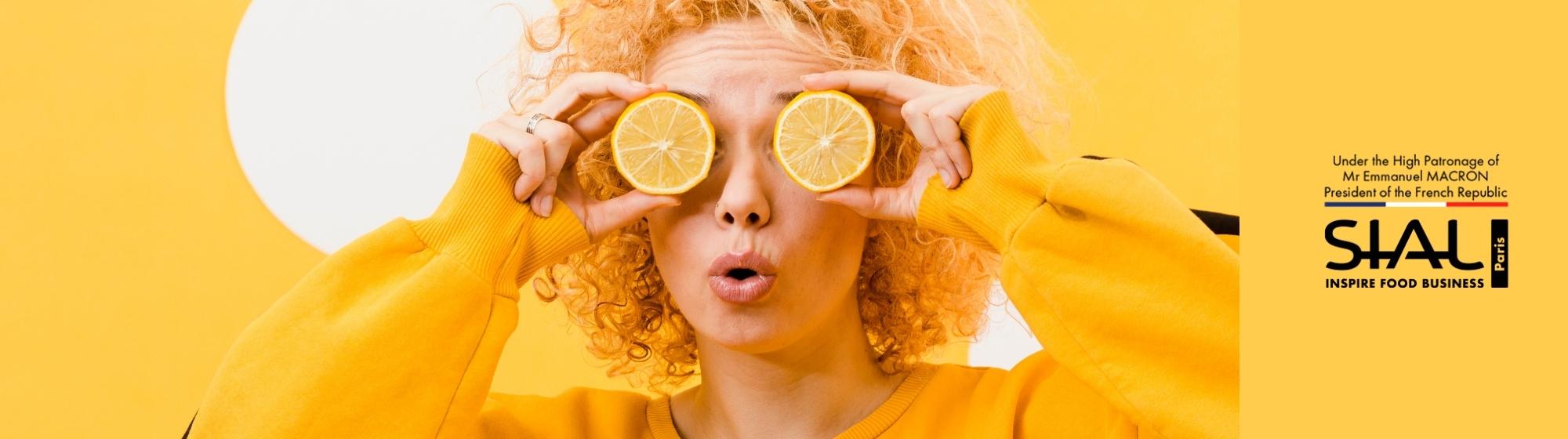 SIAL Paris creative with a woman holding lemon slices over her eyes