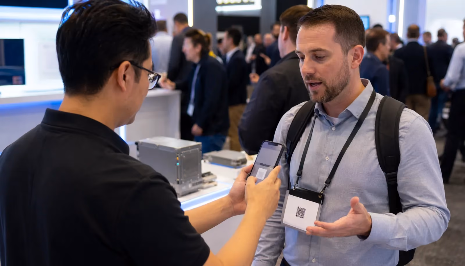 A trade show representative capturing conversation context on a mobile device