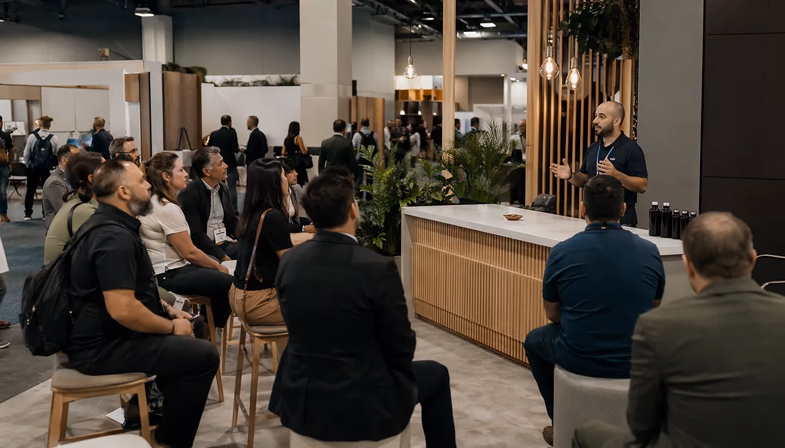 Content-led trade show booth workshop with attendees listening to a live session