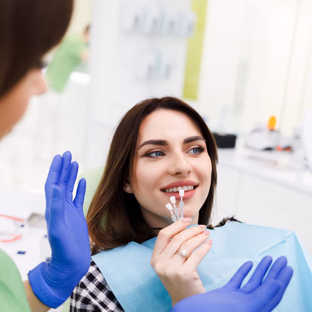 Porcelain veneer being placed on a tooth to improve shape and color