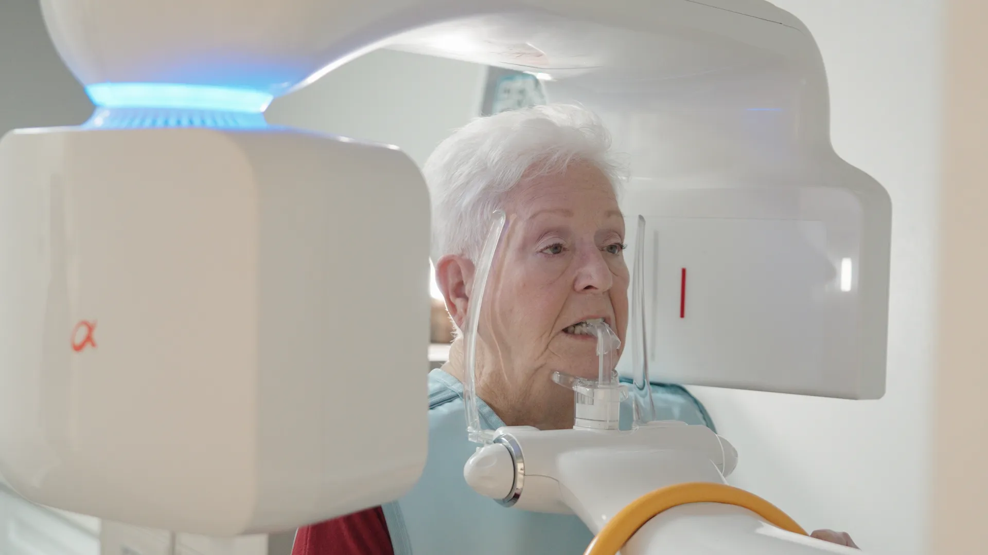 Patient receiving a panoramic dental X-ray scan at Azusa Dental Clinic.