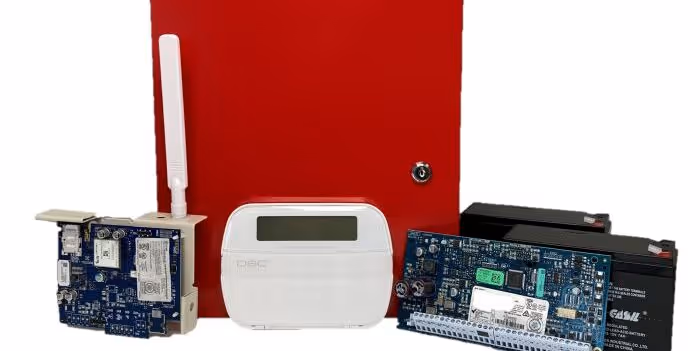 Red security panel with white keypad, circuit boards, antenna, and two black backup batteries.